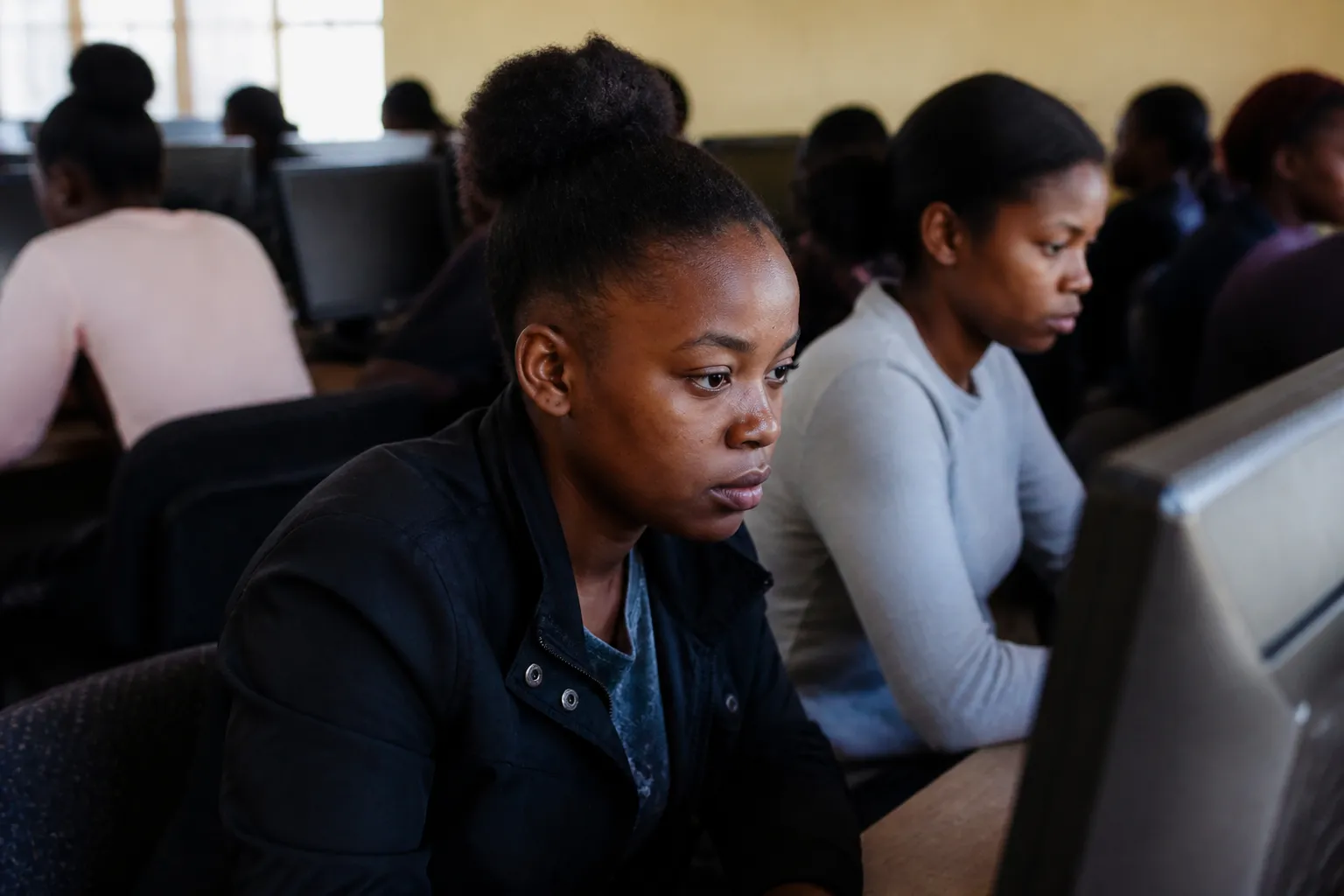 Young women use desktop computers during free classes at Bakashana’s Resource Center in Kasama.