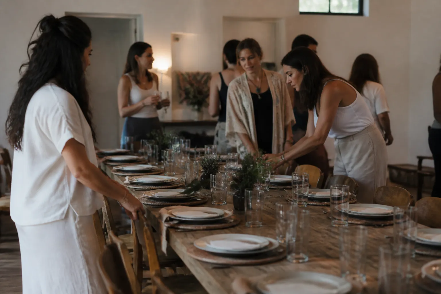 Dining table set for twelve at an Austin retreat with plates ready before a private-chef meal.