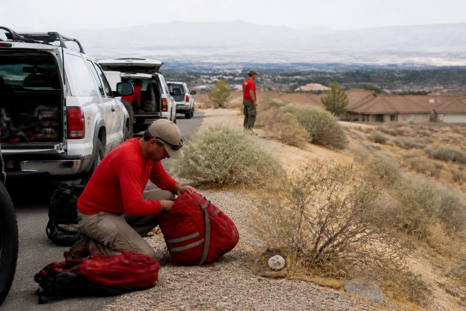 Red Rock SAR volunteers and support vehicles staged where Las Vegas neighborhoods meet desert.