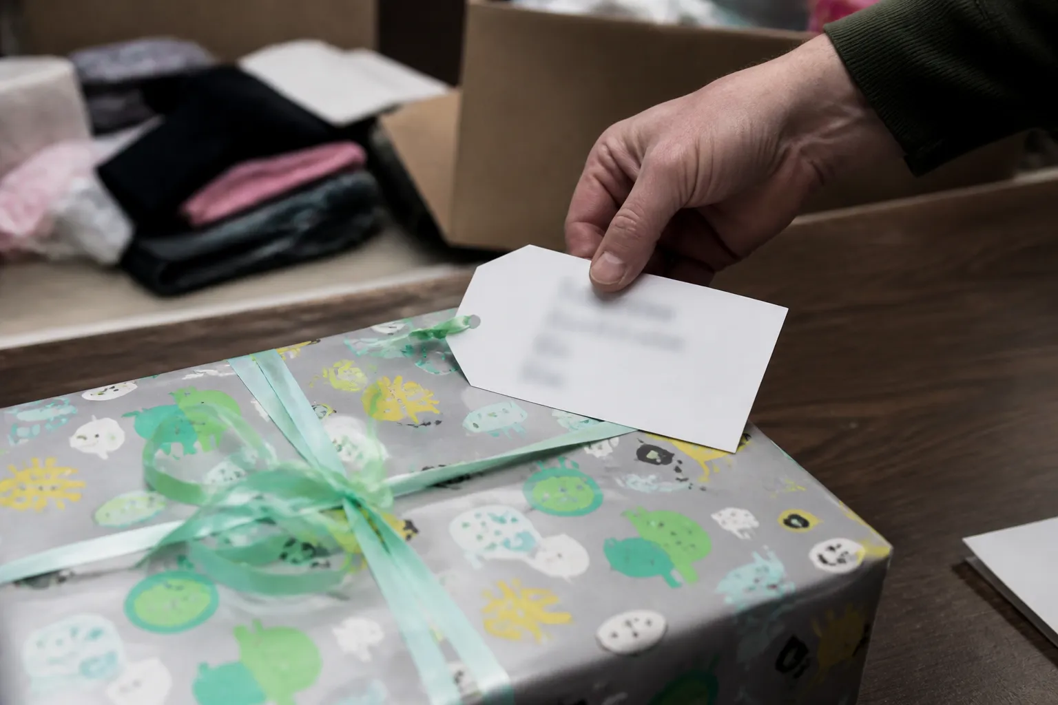Wrapped Operation Santa Claus present for a Lincoln holiday toy drive with a child-specific request tag for agency distribution.