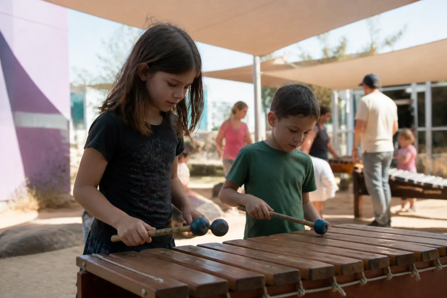 Outdoor Music Park in North Valley Music School’s north courtyard with donor-funded instruments and shade flags.