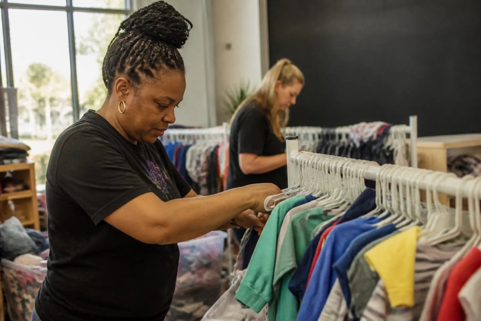 A quick guide for where to donate baby clothes in Omaha: volunteers restock children’s clothing racks before a monthly free Shopping Day at Trey’s Boutique in Downtown Ralston.