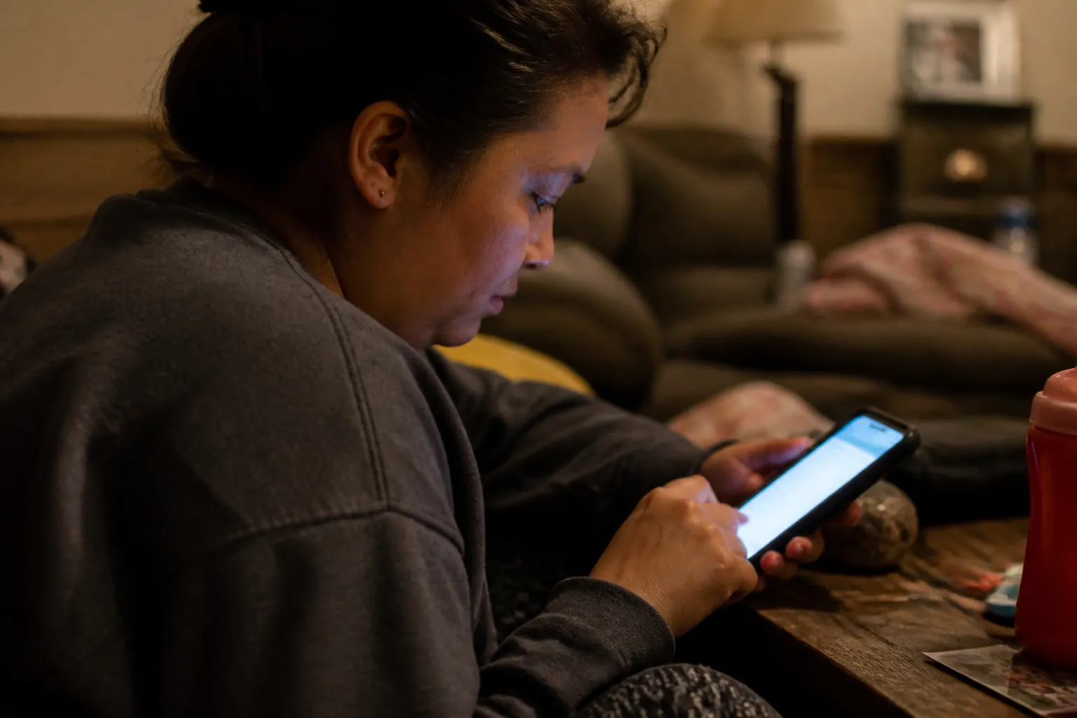 Phone screen shows holiday food donations in Lincoln NE through Lincoln Tree of Hope's Thanksgiving meal assistance application as a resident fills it out.
