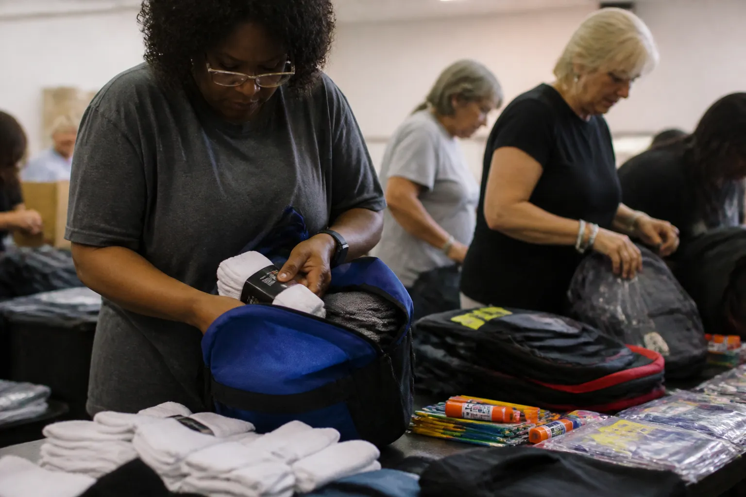 Volunteers fill backpacks during a youth programs donation event in Lincoln, NE.