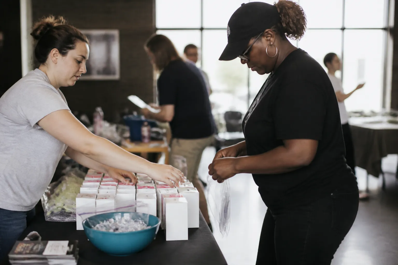 CARE Dallas volunteers set free Narcan boxes and overdose response handouts on a table at a Dallas event.