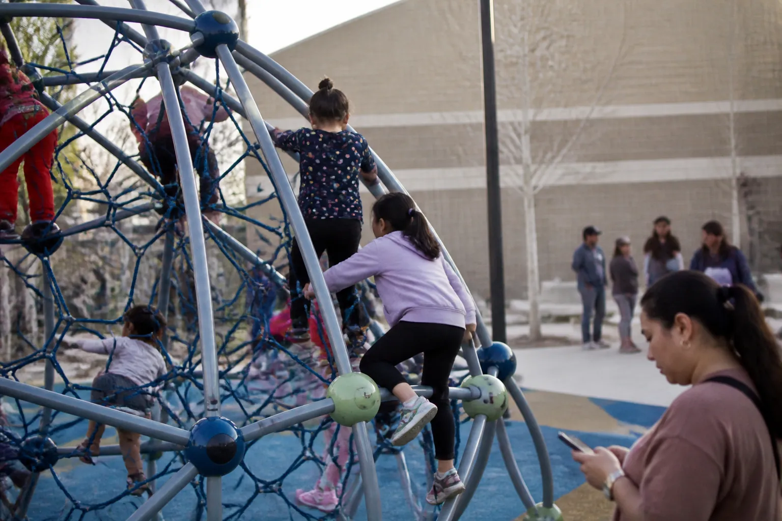 Children climb a new kid-designed playground at Donna Street Community Center in North Las Vegas after the Feb 2024 build.