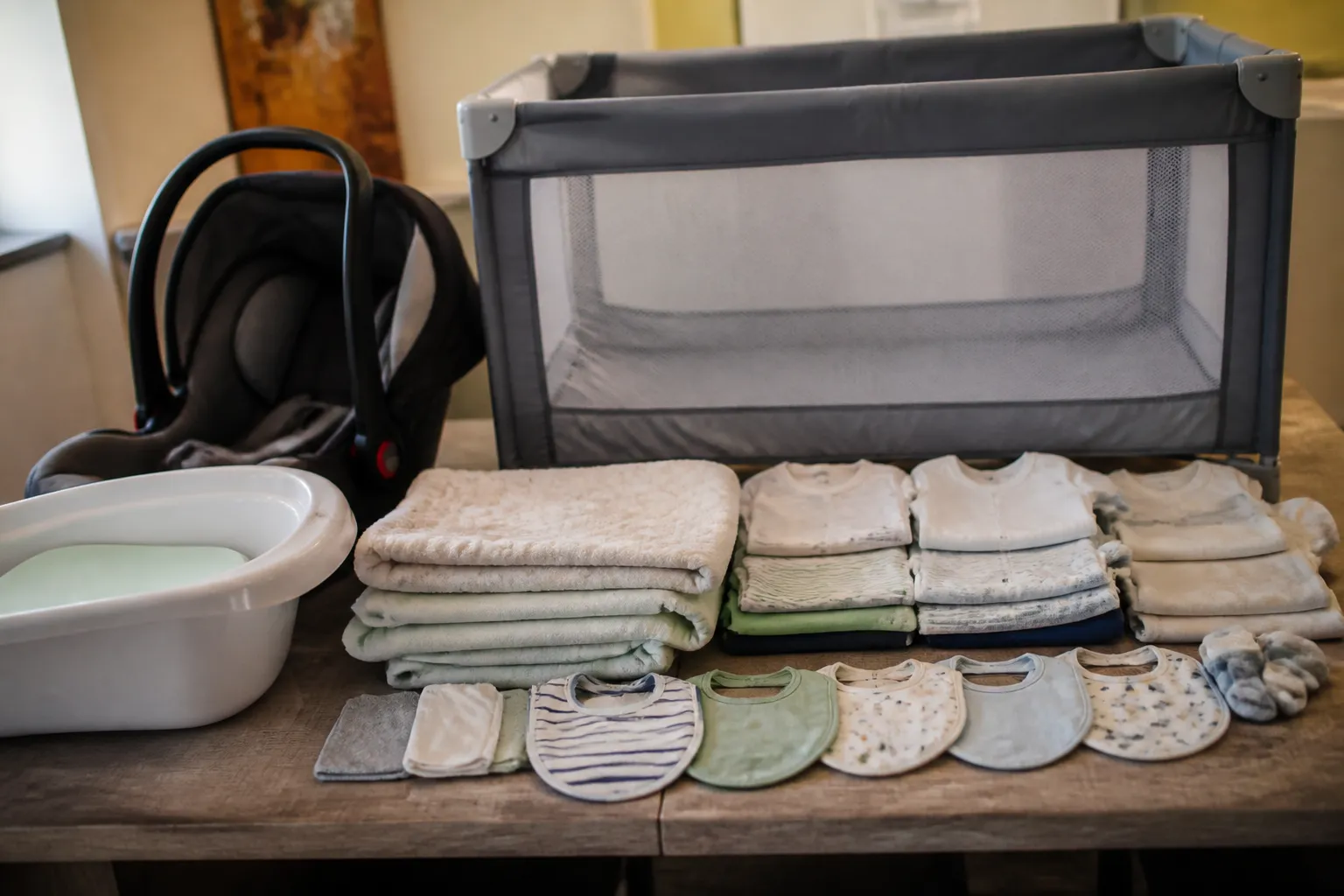 Baby Bundle items are arranged on a table in Las Vegas, including a portable crib and car seat.