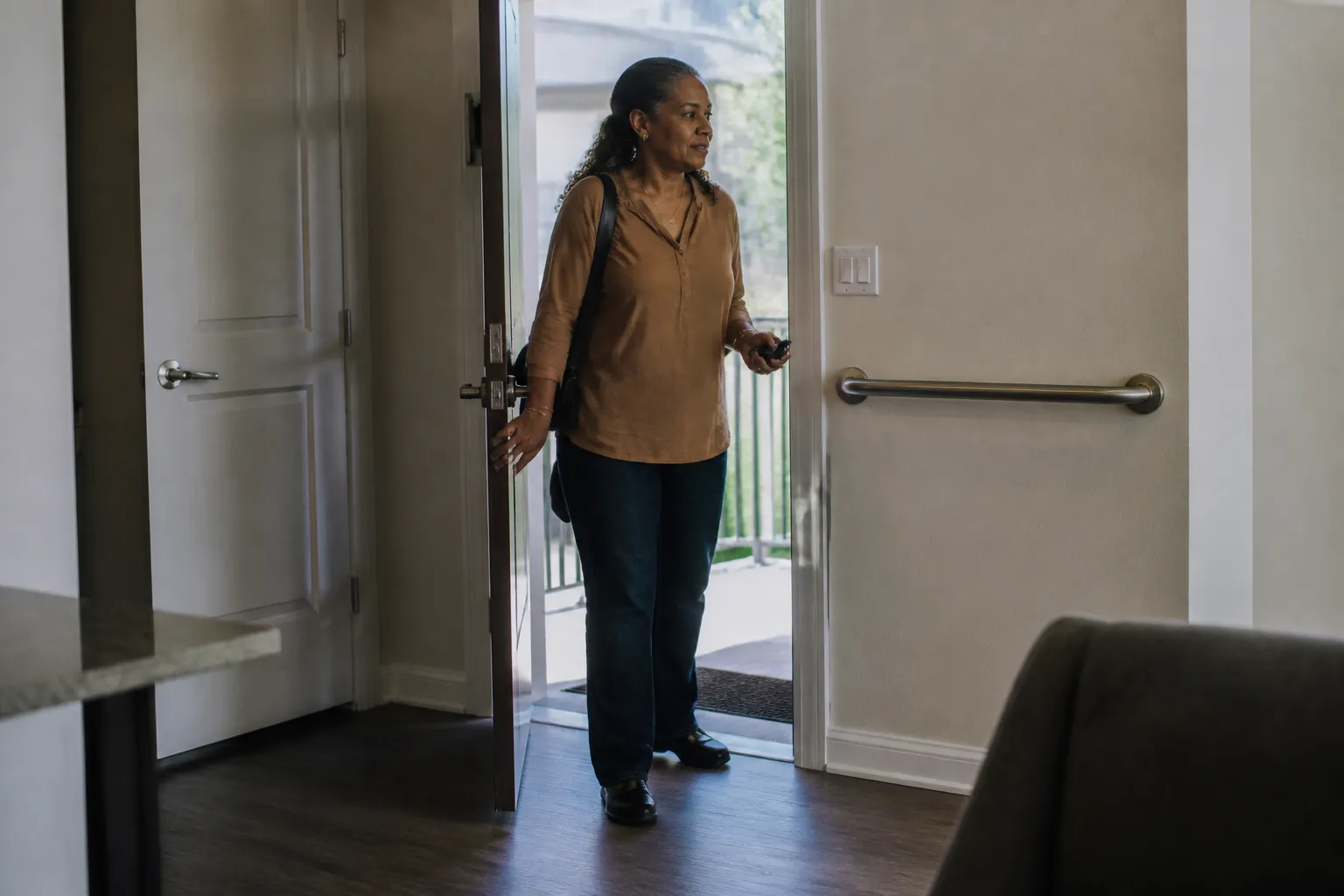 Resident enters an AHA! at Briarcliff apartment, showing accessible housing that supports economic mobility in Austin TX.