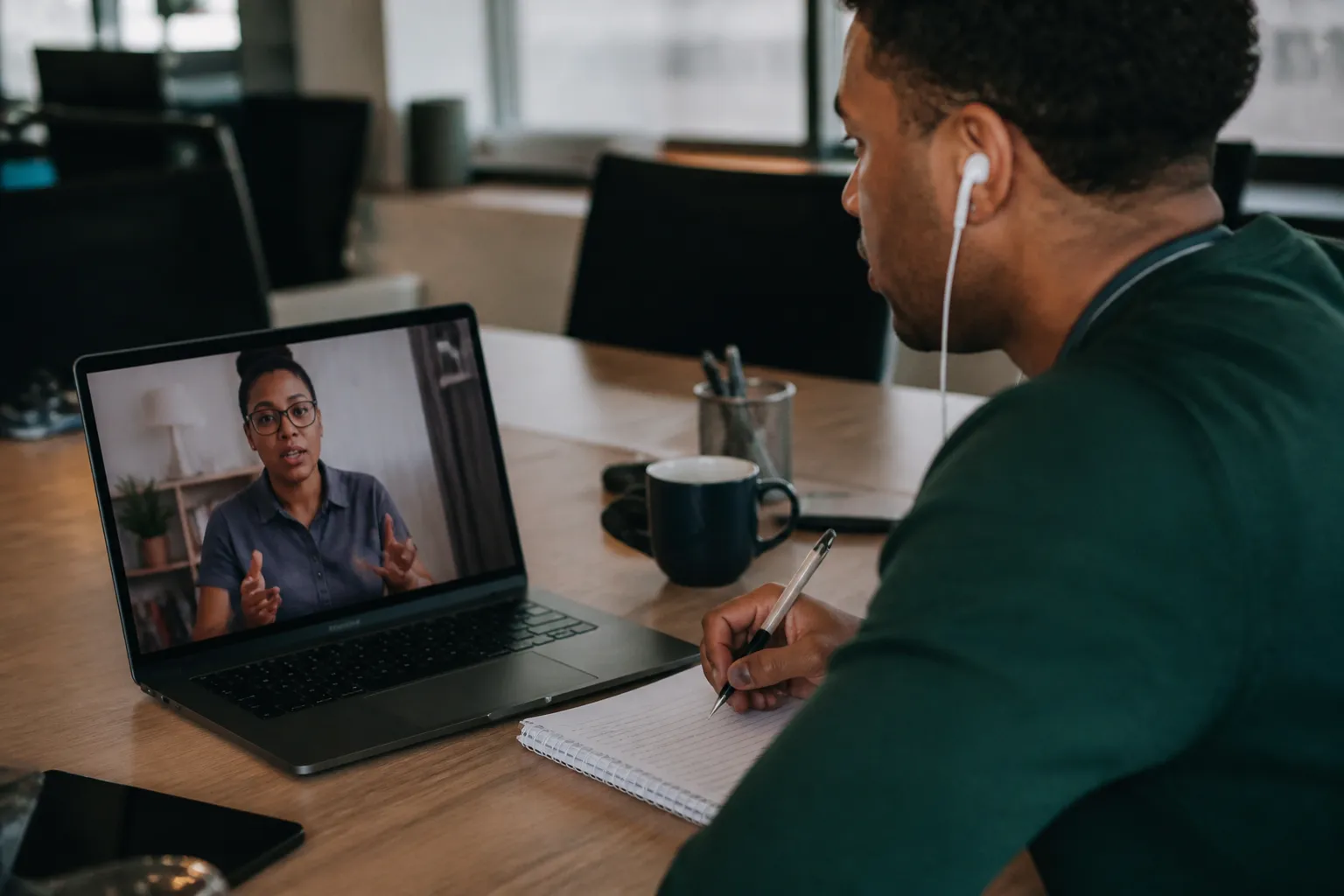 Foundation 99 coach reviews budgeting and emergency-savings goals with an employee during a live video session.