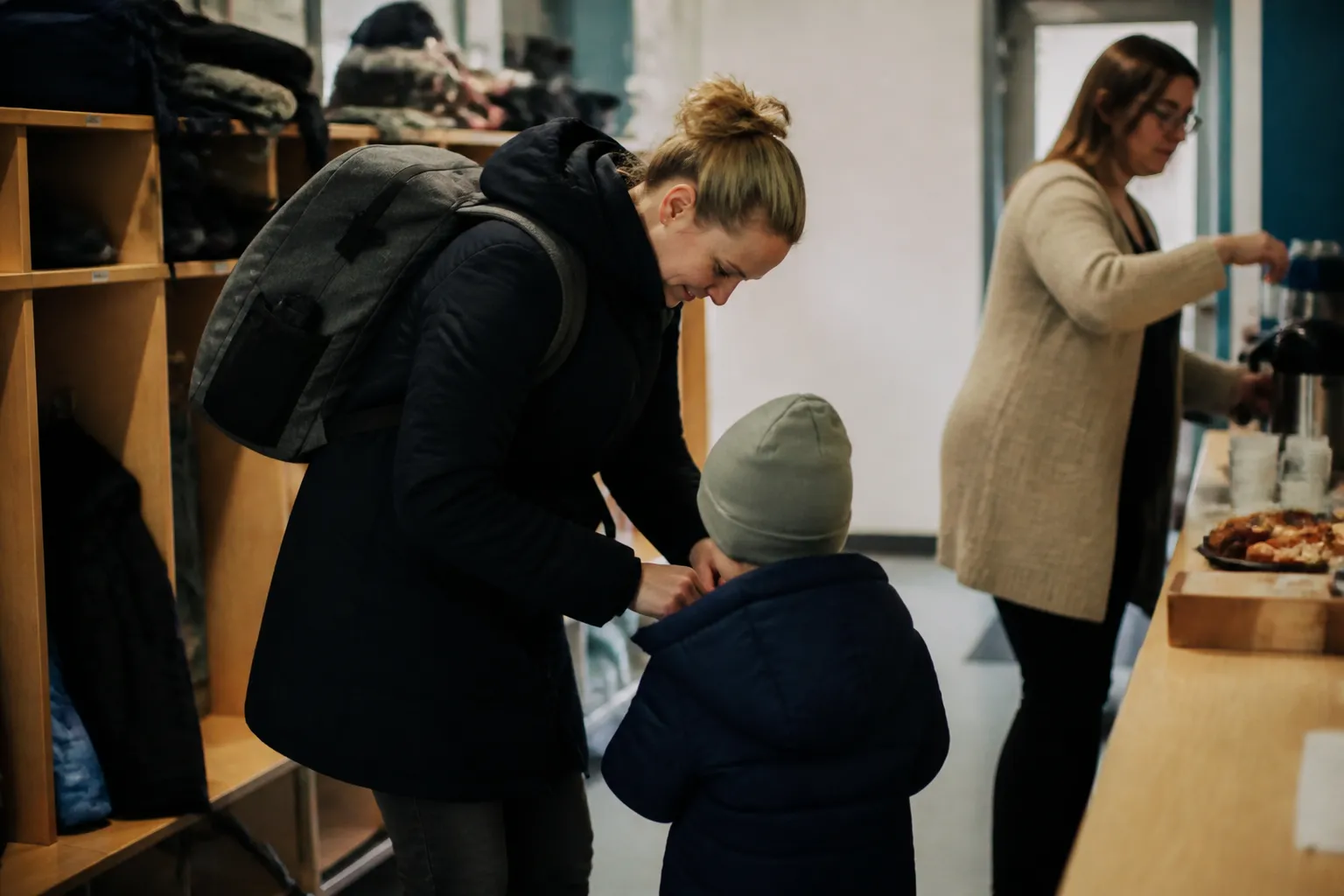 Parent drops off a child at Children’s Place in Lincoln before 6:30 a.m., with cubbies, coats, and breakfast out.